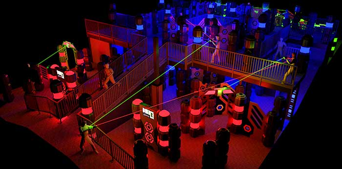 Large laser tag arena with elevated walkways and colorful lights
